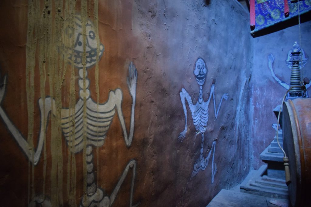 To add to the eerie atmosphere as our eyes looked away from the fearsome figures we saw the sketches of dancing skeletons on the wall.