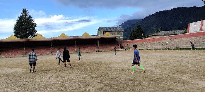 Local boys and girls practising football. Buddha Park
